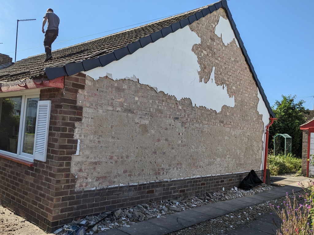 Side of bungalow - dry verge on and render off.